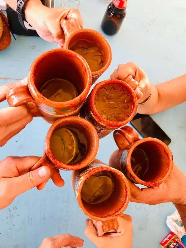 A toast in traditional clay cups at Pepez