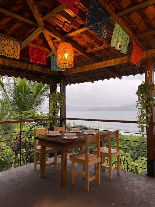 Wooden tables and papel picado inside Pepez, overlooking Bahía Ballena